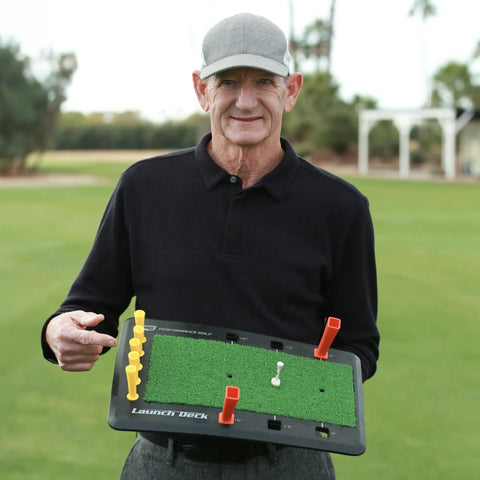Person holding Launch Deck Golf Swing Trainer For Instant Feedback, Slice Fix, And Attack Angle Mastery on a golf course