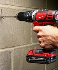 Beefy Compact Cordless Hammer Drill And Driver Kit With Half Inch Chuck And Frameless Motor in action, drilling into concrete wall.