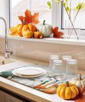 Sage Green Pumpkin Dish Drying Mat For Kitchen Counter Absorbent Microfiber Surface With Wood Grain Leaves Autumn Decor 16 By 18 Inches Machine Washable on counter near pumpkins and sink.