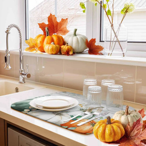 Sage Green Pumpkin Dish Drying Mat For Kitchen Counter Absorbent Microfiber Surface With Wood Grain Leaves Autumn Decor 16 By 18 Inches Machine Washable on counter near pumpkins and sink.