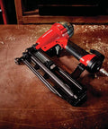 Finish Nailer 16 Gauge Pneumatic With Oil Free Motor on workbench, showcasing maintenance free operation and tool free features.