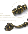 Close-up of Antique Brass Drop Bail Pulls Set Of 4 With 4-1/4 Inch Center To Center Spacing, showing zinc alloy detail and bronze finish.