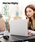 Woman using laptop connected to Six In One Charging Station With USB C And USB A Ports, Two Wide Spaced 110V Outlets, 5 Ft Cord, Black