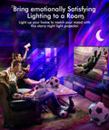Galaxy Star Projector Night Light 4 In 1 With Bluetooth Speaker White Noise And App Control Aurora Sky Nebula Colorful Stars Moon Ceiling Projection For Bedroom Game Room And Adult Chill Vibe Decor in a room with people watching a soccer game.