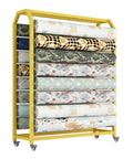 Workhorse Mobile Storage Rack With Adjustable Hanging Rod For Vinyl Rolls Fabric Spools Wrapping Paper stacked with various rolls in yellow frame.