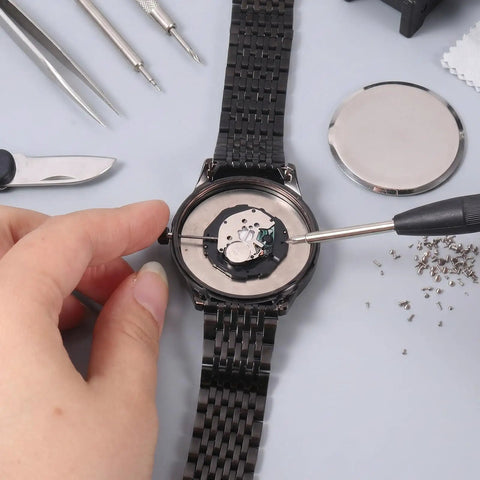 Straight Up Premium Watch Battery Clamp Screws Assortment Kit on wristwatch during repair with tools and screws visible.