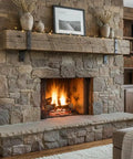 Stone fireplace with rustic wooden mantel and fire, showcasing a cozy living space. Hella Durable Reactive Water Based Voc Free Interior Wood Stain 55 Gallon Yields A Dead On Authentic Barnwood Finish With Slick Rustic Brown And Gray Undertones That Add Legit Depth To Any Major Space.