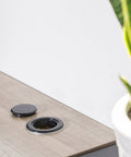 2 Inch Patio Table Umbrella Hole Ring Plug And Cap Set on wooden table, black, next to potted plant, 2 Pack