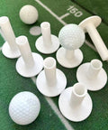 Hardcore Rubber Golf Tees For Mats And Indoor Simulators, 8 pack mixed sizes shown on green surface with golf balls, US sizes