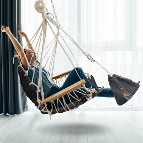 Person sitting on Patio Swing Chair With Adjustable Footrest And Headrest For A Comfy Cloudlike Sit Quilted Fabric And Steel Spreader Bar Wooden Armrests For Porch Or Garden 350 Lb Capacity Hardware Kit Included 2025 Upgrade indoors
