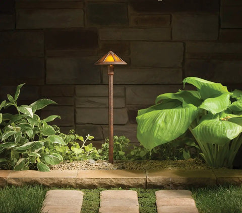 Path And Spread 1 Light 12V Outdoor Landscape Light In Textured Tannery Bronze With Mica Glass glowing in garden.