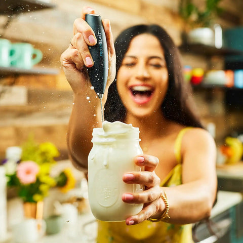 Person using Powerful Handheld Milk Frother For Coffee Lovers, Quick Foam Maker Whisk For Lattes, Cappuccinos, in kitchen