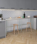 Rock Solid Heavy Duty Stainless Steel Work Table With Open Base Commercial Grade Metal Prep Bench For Restaurants Garages And Workshop Areas 84 Inch Long By 14 Inch Deep in modern kitchen setting with stools.