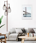 Living room with Dimmable Farmhouse Industrial Floor Lamp With Teardrop Cage Head, 70 Inch, Brown Finish next to a white sofa.