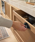 Person using Twelve Pack 2.5 Inch Matte Black Cup Pull Cabinet Handles Built Tough Zinc Alloy Drawer Hardware on kitchen drawer.