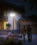 House with Triple Head Outdoor Solar Motion Light With 205 LEDs, illuminating driveway and entrance at night, weatherproof spotlight.