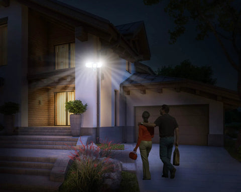 House with Triple Head Outdoor Solar Motion Light With 205 LEDs, illuminating driveway and entrance at night, weatherproof spotlight.