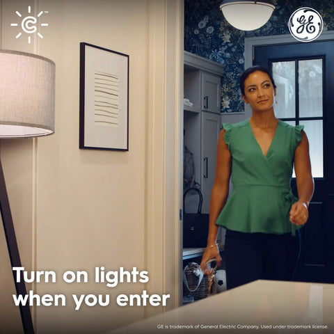 Woman entering room with Wireless Motion Sensor With Ambient Light Detection, Battery Powered, Works With Cync Smart Plugs.