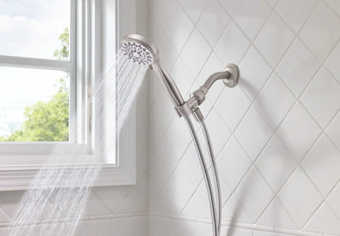 Five Function Handheld Shower Head With Brushed Nickel Spot Resistant Finish spraying water in tiled bathroom