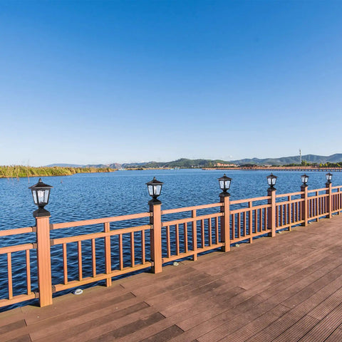Outdoor Solar Powered Post Cap Lights For 4x4 Wood Posts, lining a wooden deck rail by a lake, Classic Lantern Style, Black
