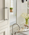 Collet 5-1/16 Inch Center-To-Center Polished Nickel Cabinet Pull on cabinet above kitchen sink