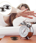 Two Piece Steel Clock Mainsprings Replacement Kit For Mechanical Clocks Wind Up Clocks beside an alarm clock on a table