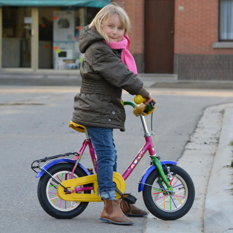 Child with pink bicycle featuring colorful 180 Pcs Spoke Covers Set For Bikes And Dirt Bikes, 10 Color Variety, Durable Plastic Rim Wraps