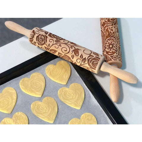 Rose Embossed Rolling Pin For Baking Cookies And Shortbread With Flower Pattern, Wooden Engraved Springerle Style Rolling Pin For Clay Pottery Ceramics, Deep Embossed Texture For Clear Impressions, shown with heart-shaped cookie dough on a baking tray.