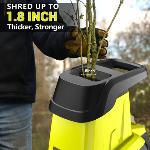 User inserting branch into Electric Wood Chipper Shredder With Fifteen Amp Motor And One Point Eight Inch Cutting Diameter