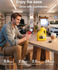 Man using Pro OBD2 Scanner Code Reader With Battery Tester in a garage for diagnostics next to car maintenance supplies.