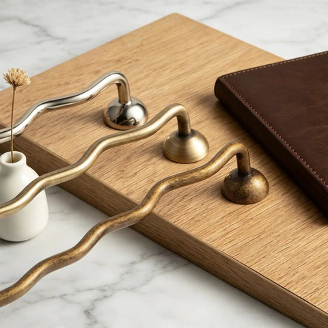 Solid Brass Cabinet Pulls With 5 Inch Hole Centers and ergonomic wave design in antique finish displayed on a wooden surface.