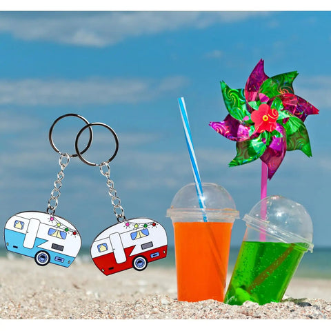 Double Sided RV Camper Keychain Set 2 Pack Retro Travel Trailer Metal Key Rings on beach with drinks and pinwheel