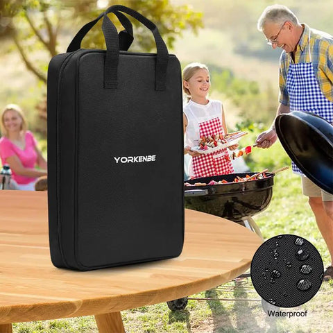 Black waterproof High Capacity Camp Kitchen Organizer Bag With Hanging Hooks And Paper Towel Holder shown on a picnic table.