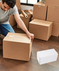 Person packing with Ten Box Set Of White Corrugated Cardboard Shipping Boxes With Standard Design And Lightweight Paper Material