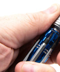 Close-up of hand holding Pro Grade Do It All RC Tool Set For Air And Surface Startups with aluminum handle, detailed view.