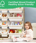 Child sitting beside Kiddo Friendly Toy Storage Organizer With Bookshelf, Three Shelves And Twelve Bins, White Pine Wood Toy Cabinet