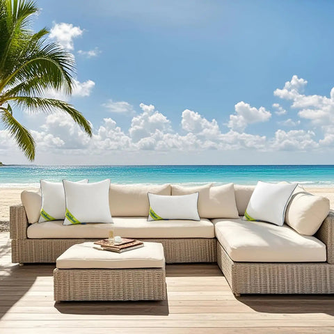Outdoor 18x18 Inch Waterproof Pillow Inserts Pack Of 2 on a wicker sofa set by the beach, showing water-resistant design.