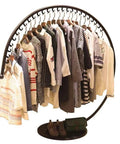 Curved clothing rack displaying shirts and jackets, shoes at base, Industrial Style Heavy Duty Coat Rack For Home And Store Display Freestanding Clothing Rack With Nano Coated Glossy Finish And Anti Oxidation Durability 120 By 130 Cm Gold Tone