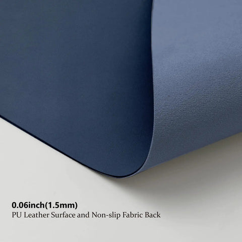 Close-up of dark blue Leather Desk Pad For Home Office And Workspace Non Slip PU Desk Mat Large Desk Pad With Protective Surface Ideal For Mouse And Keyboard Desk Organization Dark Blue 31.5 By 15.7 Inches showing PU surface and non-slip fabric back; 0.06 inch thick (1.5mm)