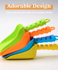 Stacked Colorful Beach Shovels For Kids Set Of 4 Durable Plastic Sandbox Toys shown in green, orange, blue, and yellow.