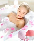 Woman relaxing in a bubble bath with pink rose petals, featuring bath bombs from the 200 Pack 6x6 Inch Shrink Wrap Bags set