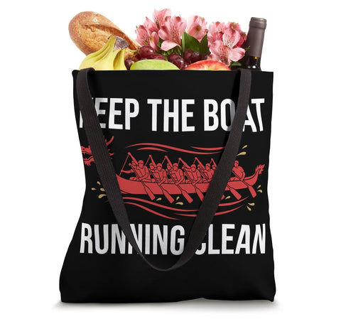Black tote bag with 'Keep The Boat Running Clean' slogan and dragon boat design, filled with groceries. Paddling Crew Tote Bag For Dragon Boat Team And Racing Enthusiasts, Durable Water Resistant Gear For Club Practice And Race Day, Lightweight Carryall For Synchronized Strokes, Endurance Training, And Team Rhythm On The Water.
