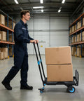 Warehouse worker moving boxes with Two In One Folding Hand Truck Dolly Workhorse With Four Quiet TPR Wheels And 3 Level Adjustable Handle For Luggage Travel Office Moving Camping Outdoor Use Black Blue