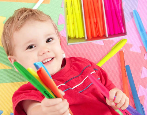 Child holding Chisel Tip Highlighters 96 Count Bulk Pack Assorted Fluorescent Colors No Bleed Through Smudge Proof in playroom