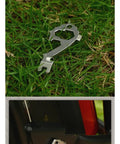 Stainless Steel Keychain Tool Pocket Multi Tool 6 Pack With Bottle Opener And Hex Wrench Cutouts on grass and in use on bike.