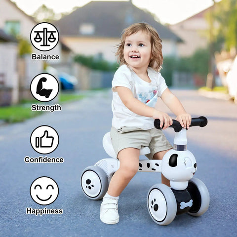 Toddler riding Mini Balance Bike Toy for 10-36 months, blink eye spotty dog design with enclosed wheels and 135-degree turn limit.