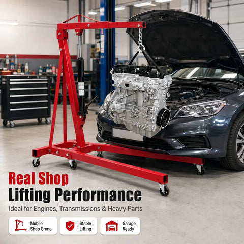 Built Tough 2 Ton Hydraulic Engine Hoist Bringing 4400 Lbs Of Serious Lifting Muscle To Your Shop With Six Swivel Wheels For Hell Of A Smooth Ride And Zero Mess Folding Crane Performance in a workshop lifting an engine.