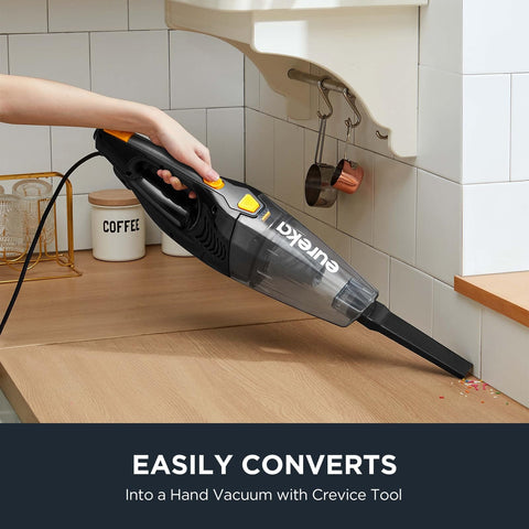 Person using Blaze 3 In 1 Stick Vacuum Cleaner With Powerful Suction Lightweight Four Pound Handheld For Quick Cleanups On The Go Onboard Crevice Tool Great For Hard Floors And Pet Hair to clean crumbs on a countertop.