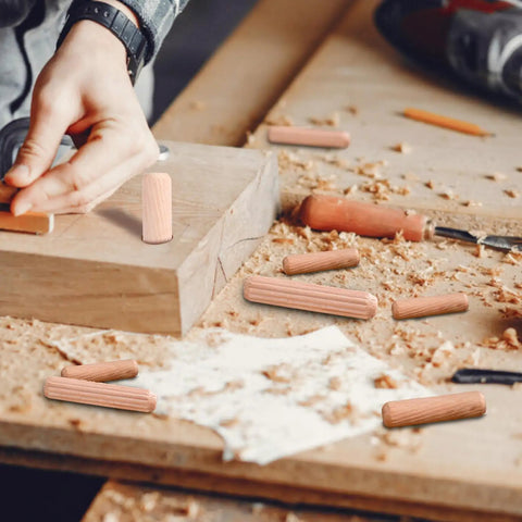 Top Shelf Wooden Dowel Pins Featuring Fluted Hardwood Rods For Furniture Repairs And Craft Builds Supplies Ninety Pieces in use on woodworking surface.