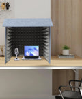 Desktop Acoustic Booth Foldable Three Sided Recording Isolation Shield With High Density Sound Absorbing Foam on a desk with a laptop and microphone.